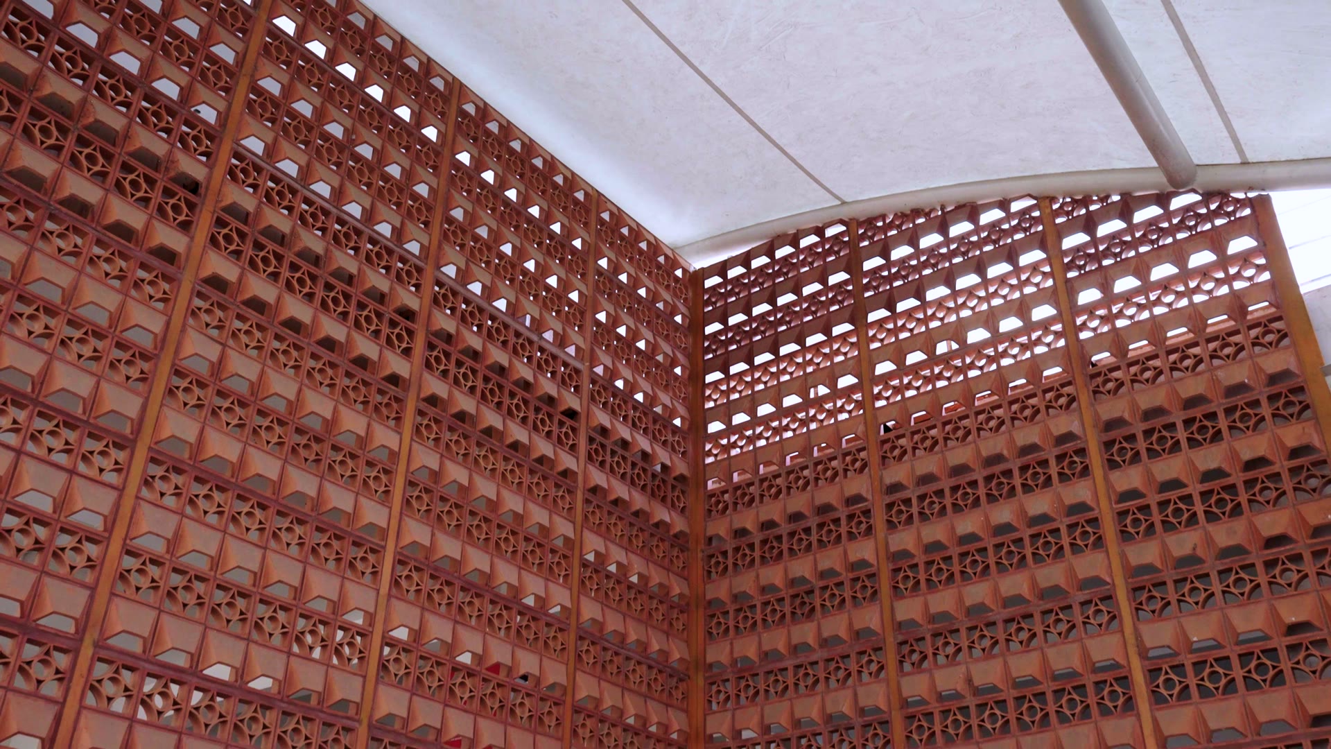 Terracotta jali screen at Rayanapadu railway station, seen from under the canopy